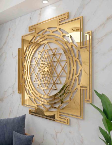 Large metal Shree Yantra wall hanging in gold on a living room wall